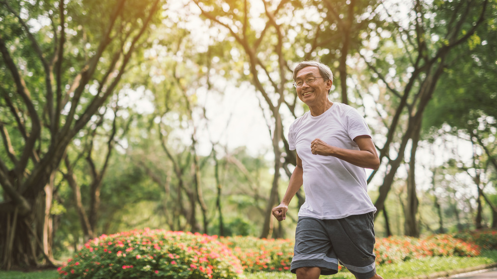 Older man running in park