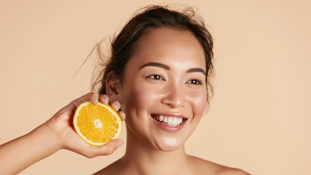 woman holding orange